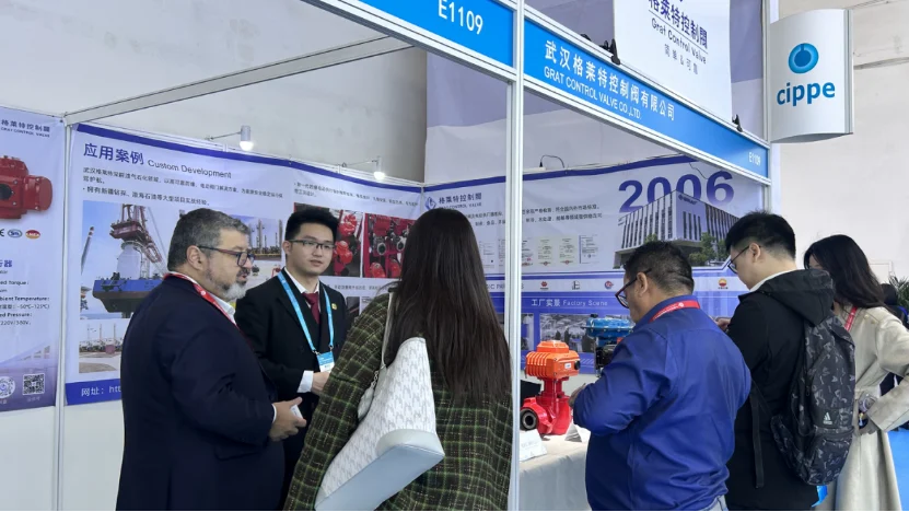 GRAT Showcases Intelligent Flow Control Solutions at CIPPE 2026 in Beijing 2 Wuhan GRAT Control Valve Co., Ltd. sales team engaging with international clients at CIPPE exhibition, showcasing advanced industrial control valves at booth E1109.