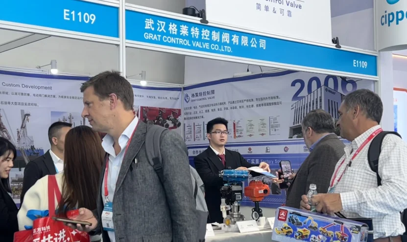 GRAT Control Valve Co., Ltd. booth at the CIPPE exhibition. The image shows our professional team engaging with international clients and demonstrating industrial electric and pneumatic actuators and control valve solutions.